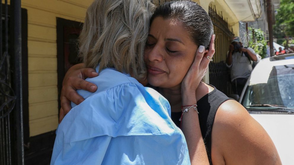 Karen Caballero, the mother of Fernando Redondo Caballero and Alejandro Andino Caballero who died near San Antonio, Texas, after being discovered in a hot trailer full of migrants being smuggled into the US, is comforted during an impromptu conferenc