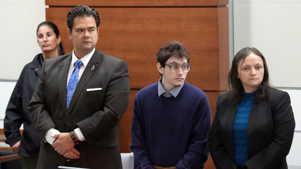 Marjory Stoneman Douglas High School shooter Nikolas Cruz stands with his attorneys, Chief Assistant Public Defender David Wheeler and sentence mitigation specialist Kate O'Shea as prospective jurors enter the courtroom for jury pre-selection in the 