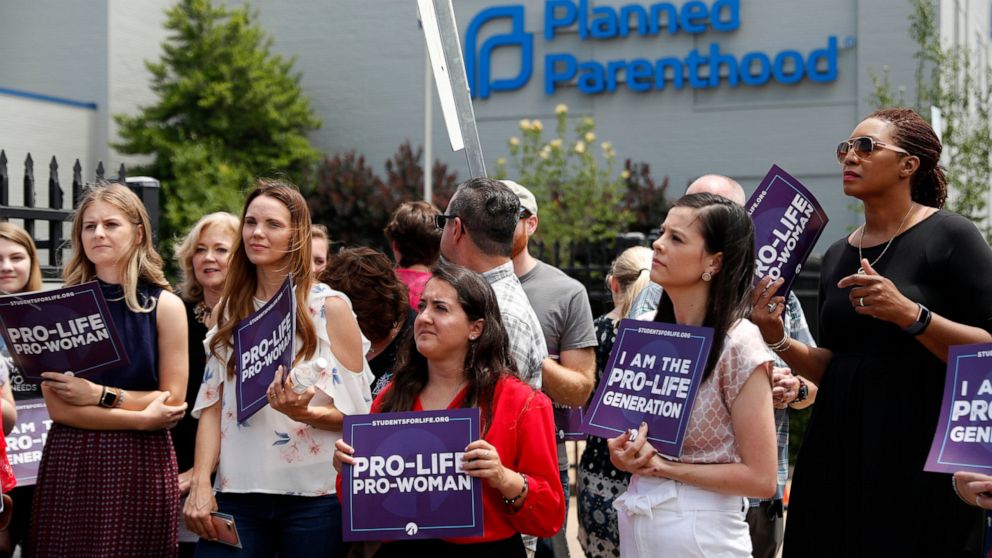 FILE - In this June 4, 2019, file photo, anti-abortion advocates gather outside the Planned Parenthood clinic in St. Louis. A federal appeals court on Tuesday, Sept. 21, 2021, will consider whether Missouri can implement a sweeping law aimed at limit