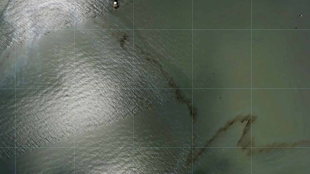 Photos captured by National Oceanic and Atmospheric Administration aircraft Tuesday, Aug. 31, 2021 and reviewed by The Associated Press show a miles long black slick floating in the Gulf of Mexico near a large rig marked with the name Enterprise Offs