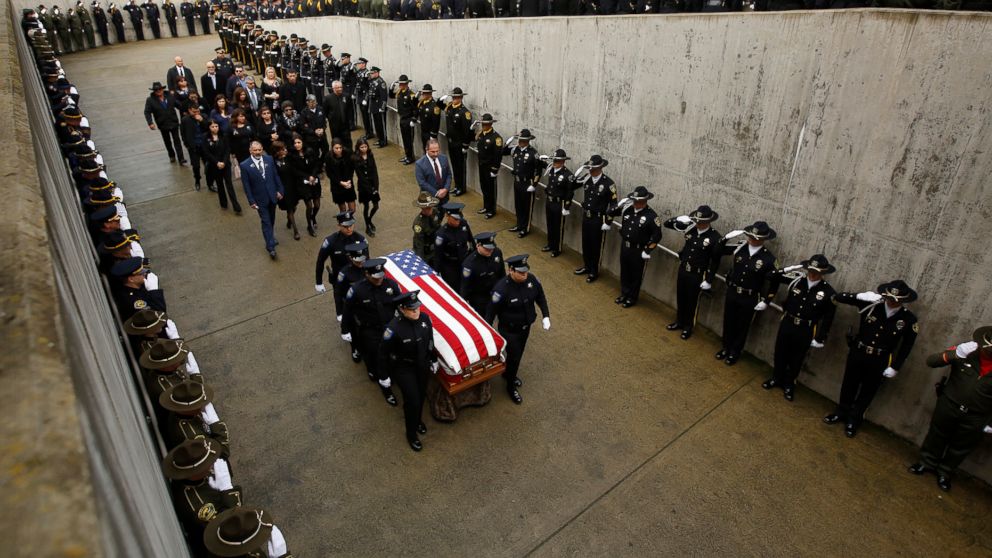 Family members follow the flag draped coffin of Davis Police Officer Natalie Corona before funeral services for Corona at the University of California, Davis, Friday, Jan. 18, 2019, in Davis, Calif. Corona was was shot and killed Jan. 10, responding 