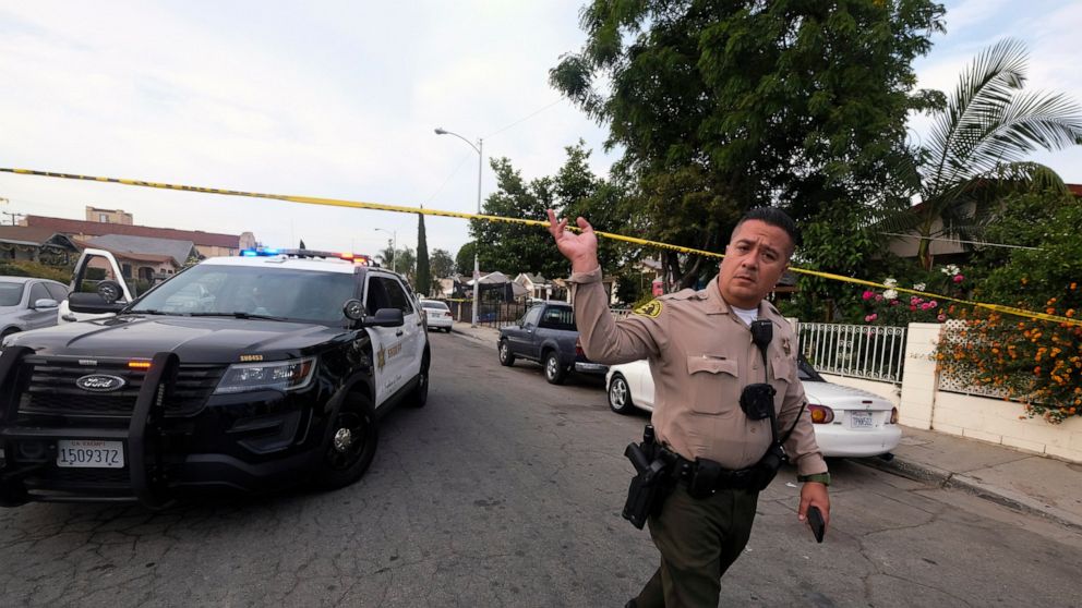 A Los Angeles County Sheriff's official works on the scene after three young children were found dead in a bedroom at a residence in East Los Angeles, Monday, June 28, 2021. (AP Photo/Ringo H.W. Chiu)