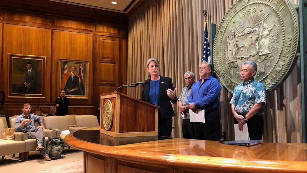 Hawaii Attorney General Clare Connors talks to reporters in Honolulu on Friday, Sept. 13, 2019 about threats state employees have received amid the heated debate over building a giant telescope on the state's highest peak. Behind her are Department o