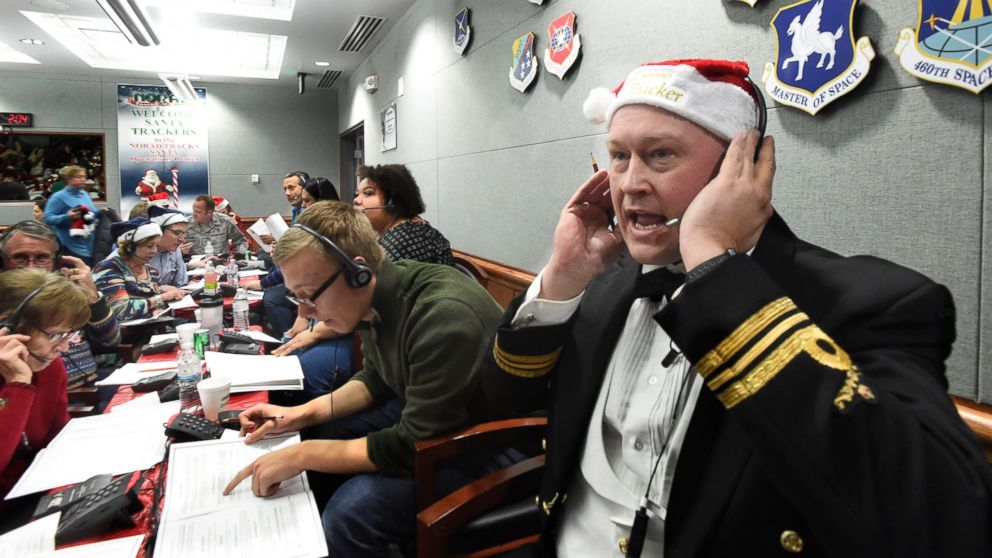 FILE – In this Dec. 24, 2017, file photo, Canadian Lt. Maj. Chris Hache takes a call while volunteering at the NORAD Tracks Santa center at Peterson Air Force Base in Colorado Springs, Colo. Hundreds of volunteers will help answer the phones again wh