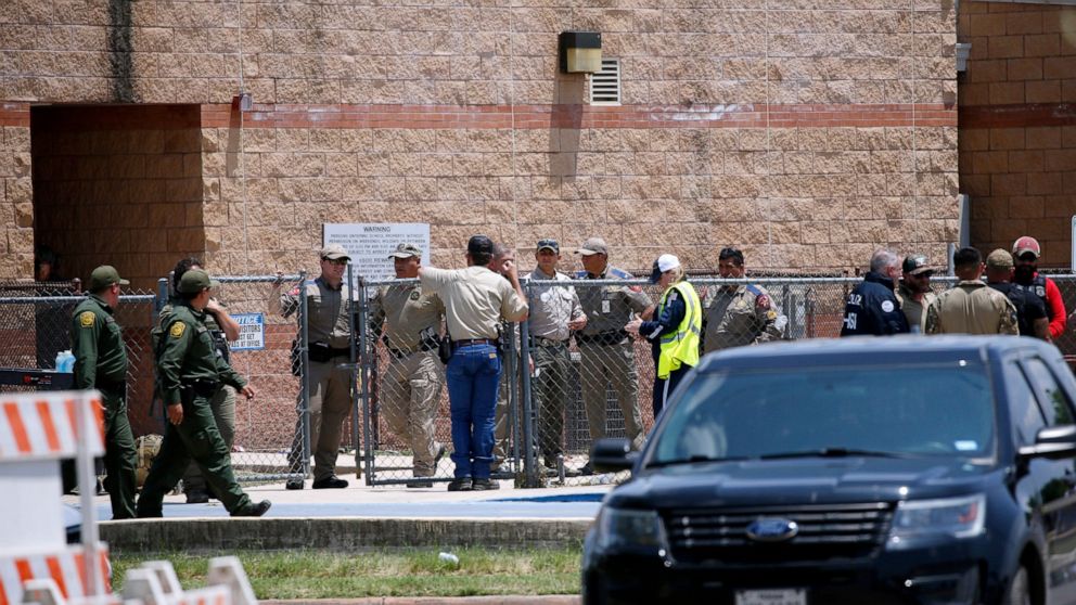 FILE - Law enforcement, and other first responders, gather outside Robb Elementary School following a shooting, May 24, 2022, in Uvalde, Texas. The children who survived the attack, which killed 19 schoolchildren and two teachers, described a festive