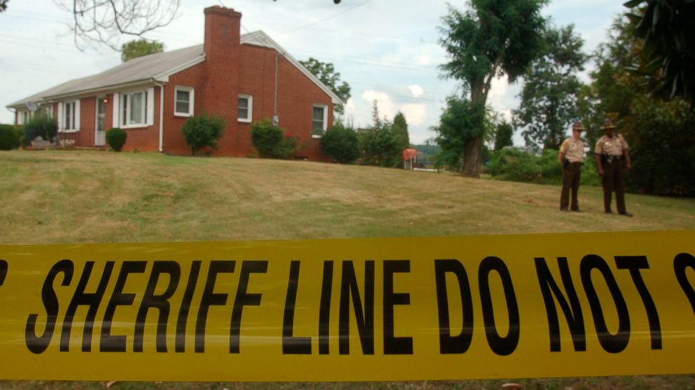 In this Aug. 16, 2002, file photo, police have taped off the area surrounding the Short residence in Bassett, Va., where authorities said they still had no suspects in the slayings or in the disappearance of Jennifer Renee Short, who vanished from th