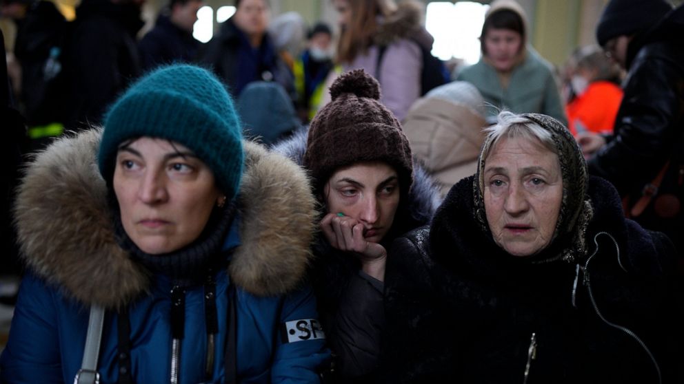 Three generations of women from right, Svetlana, Lisa and Ludmilla, who originally fled from Odessa, Ukraine, arrive at the train station in Przemysl, Poland, after crossing the border in Kroscienko, Poland, Tuesday, March 8, 2022. U.N. officials sai