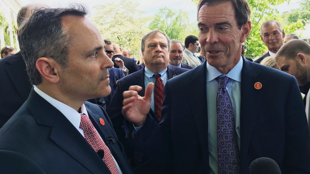 FILE - Braidy Industries Inc. CEO Craig Bouchard, right, and then-Republican Kentucky Gov. Matt Bevin speak with reporters in Wurtland, Ky., on April 26, 2017. Braidy Industries still needs to raise $500 million to build a long-promised $1.7 billion 