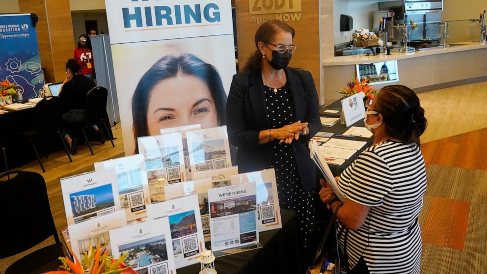 Marriott human resources recruiter Mariela Cuevas, left, talks to Lisbet Oliveros, during a job fair at Hard Rock Stadium, Friday, Sept. 3, 2021, in Miami Gardens, Fla. Federal Reserve policymakers at a meeting last month said the U.S. job market was