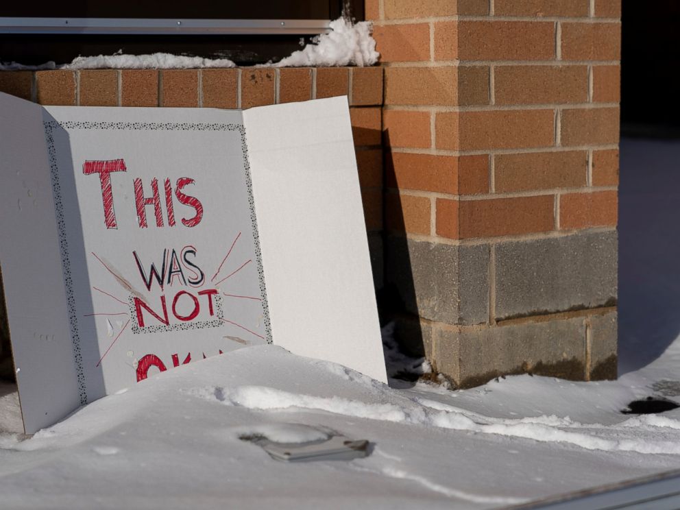 A sign reading This was not okay, is seen in front of Covington Catholic High School in Park Kills, Ky., Sunday, Jan 20, 2019. A diocese in Kentucky has apologized after videos emerged showing students from the Catholic boys high school mocking Na