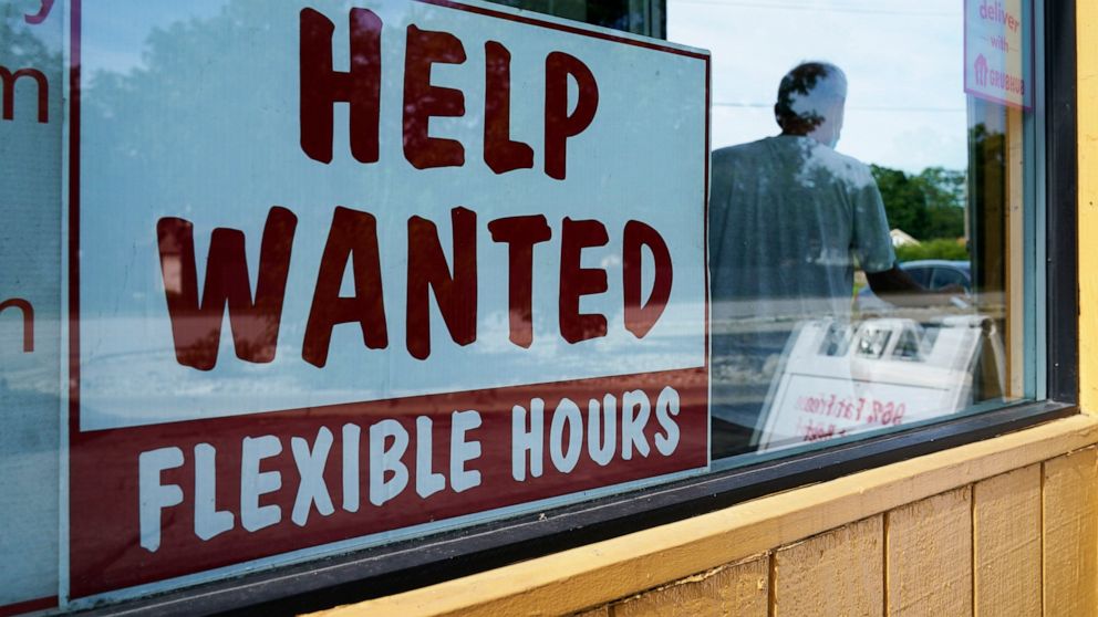 Help wanted sign is displayed in Deerfield, Ill., Wednesday, Sept. 21, 2022. The number of available jobs in the U.S. plummeted in August compared with July, a sign that businesses may pull back further on hiring and potentially cool chronically high