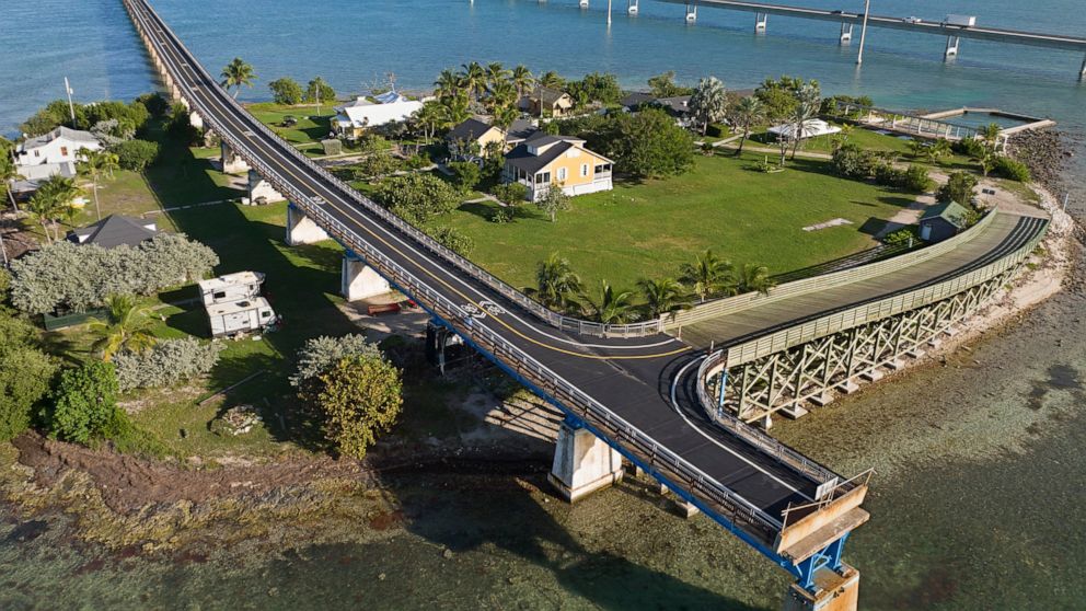 This Monday, Jan. 10, 2022, drone aerial photo provided by the Florida Keys News Bureau shows the Old Seven Mile Bridge ready for its Wednesday, Jan. 12, 2022, reopening to pedestrians, bicyclists, anglers and visitors to Pigeon Key (island shown in 
