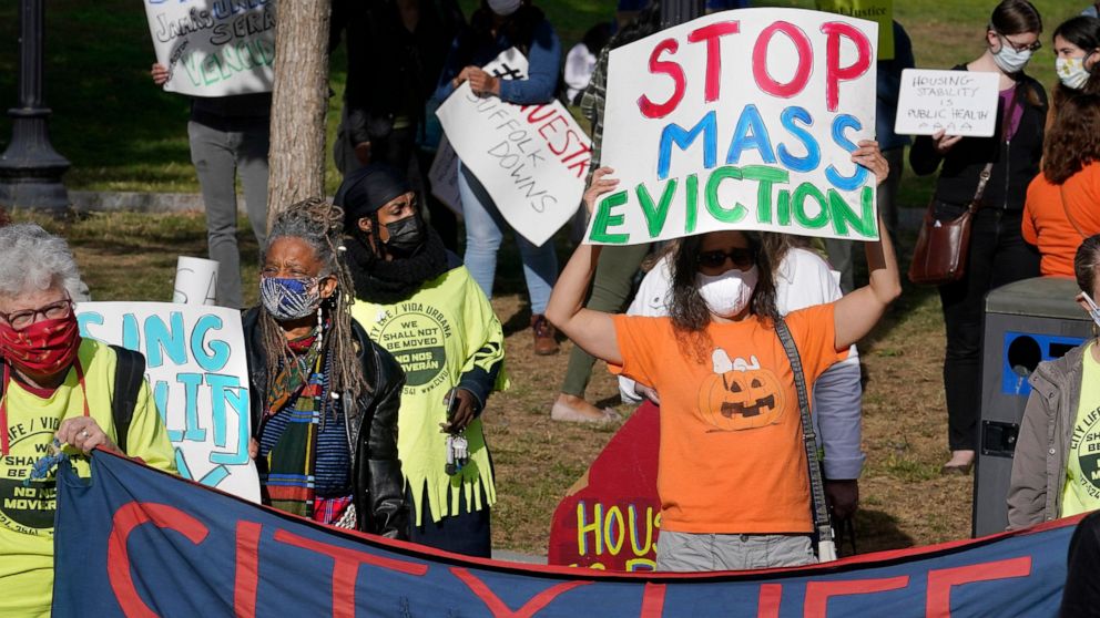 FILE - In this Oct. 11, 2020 file photo, protesters display placards while calling for support for tenants and homeowners at risk of eviction during a demonstration on the Boston Common, in Boston. The foreclosure moratorium, which bars foreclosures 