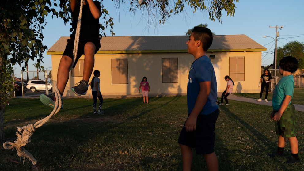 FILE - Children play in the yard of a community boxing club Thursday, Aug. 19, 2021, in Somerton, Ariz. The U.S. Census Bureau on Thursday, March 10, 2022, released two reports which measure how well the once-a-decade head count tallied every U.S. re