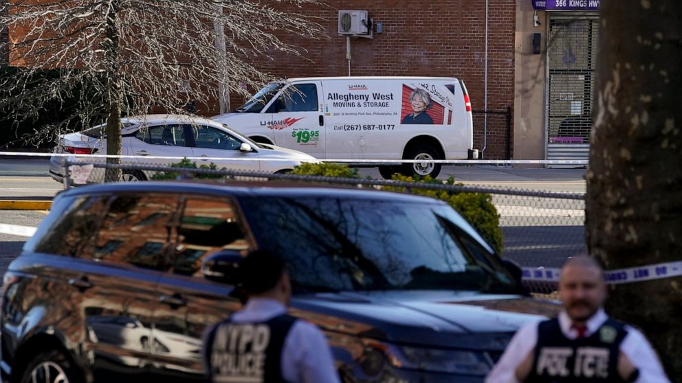 Emergency personnel form a perimeter around a U-Haul van during an ongoing investigation in the Brooklyn borough of New York, Tuesday, April 12, 2022. Multiple people were shot and injured Tuesday at a subway station in New York City during a morning