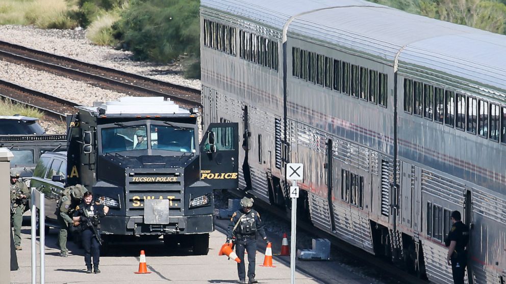 FILE - In this Oct. 4, 2021, file photo, a Tucson Police Department SWAT truck is parked near the last two cars of an Amtrak train in downtown Tucson, Ariz., following a shooting. The man who died in a gunfight in Tucson this month with law enforceme