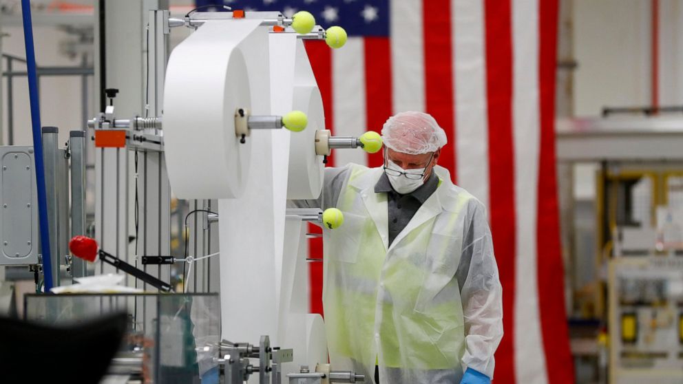 Bill Merkle works on making protective masks in Warren, Mich., Thursday, April 23, 2020. General Motors has about 400 workers at the now-closed transmission plant in suburban Detroit. All over the country, blue-collar and salaried workers have raised