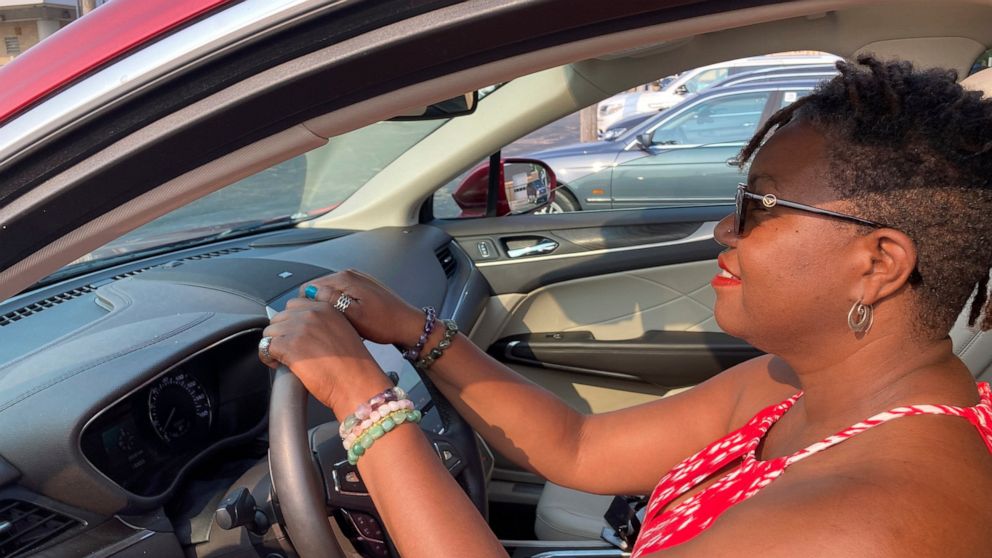Jessica Pitts sits behind the wheel of a 2019 Lincoln MKC on the lot of Jack Demmer Lincoln in Dearborn, Mich., on Monday, July 19, 2021. Pitts bought the used car at the dealership. A seemingly endless streak of skyrocketing used vehicle prices is f