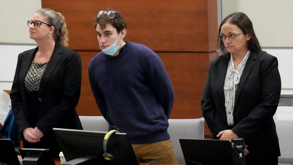 Marjory Stoneman Douglas High School shooter Nikolas Cruz, center, stands with members of his defense team as jurors enter the courtroom during the penalty phase of Cruz's trial at the Broward County Courthouse in Fort Lauderdale, Fla., on Thursday, 
