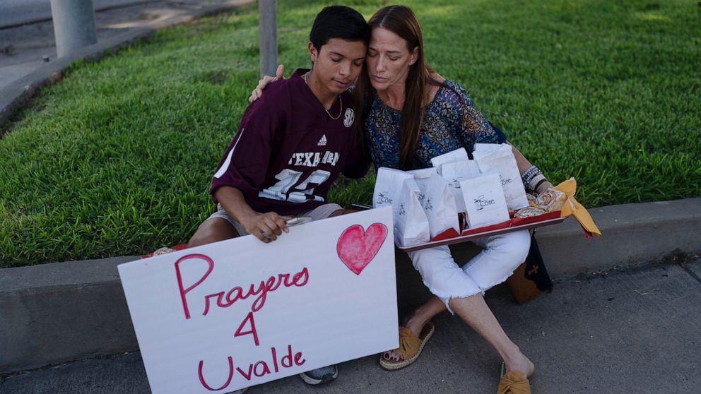 Diego Esquivel, left, and Linda Klaasson comfort each other as they gather to honor the victims killed in Tuesday's shooting at Robb Elementary School in Uvalde, Texas, Wednesday, May 25, 2022. Desperation turned to heart-wrenching sorrow for familie