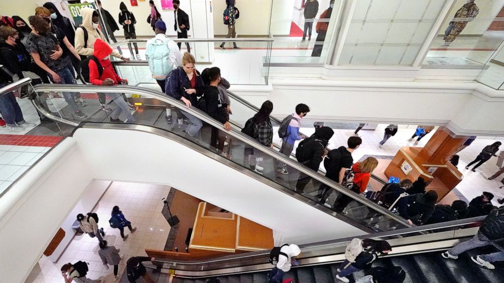 Students commute between classes at Downtown Burlington High School, Monday, March 22, 2021, in Burlington, Vt. Students who once shopped at a downtown mall are now attending high school in the mall's former Macy's department store, taking escalators