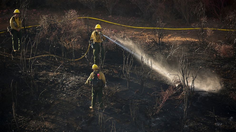 Hand crews work on the remaining hot spots from a brush fire at the Apple Fire in Cherry Valley, Calif., Saturday, Aug. 1, 2020. (AP Photo/Ringo H.W. Chiu)