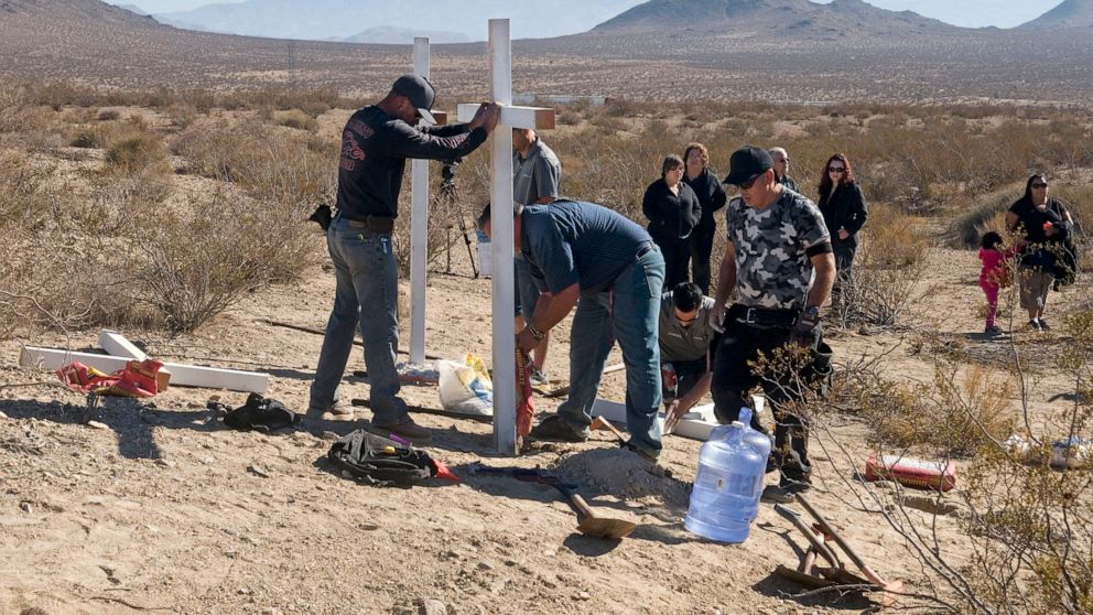 FILE - In this Nov. 20, 2013, file photo, residents of Victorville, Calif., and surrounding communities place crosses near the graves where the McStay family was found in Victorville, Calif. A jury verdict will be read in the case of a Southern Calif