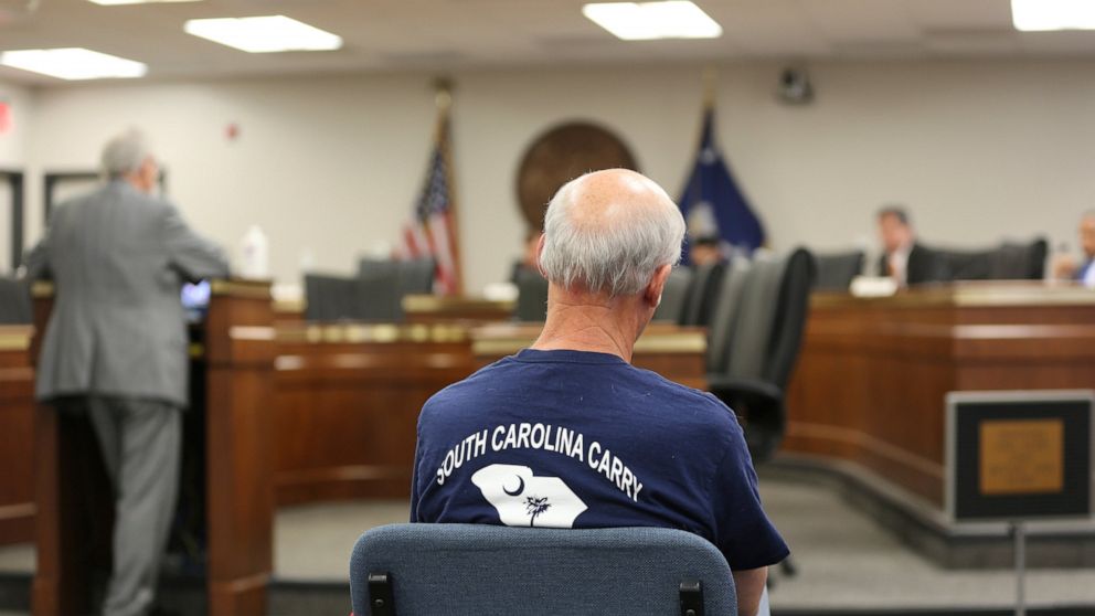 A supporter of a bill to allow people in South Carolina who already have concealed weapons permits to carry their guns in the open listens to a Senate subcommittee hearing on the proposal on Tuesday, April 27, 2021, in Columbia, S.C. The bill doesn't