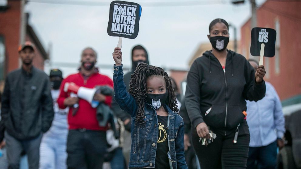 Six-year-old Diamond Wood marches through the streets of downtown Elizabeth City, N.C., Friday, April 23, 2021. Several days of protests followed the shooting death of Andrew Brown Jr. on Wednesday by sheriff's deputies serving drug-related search an