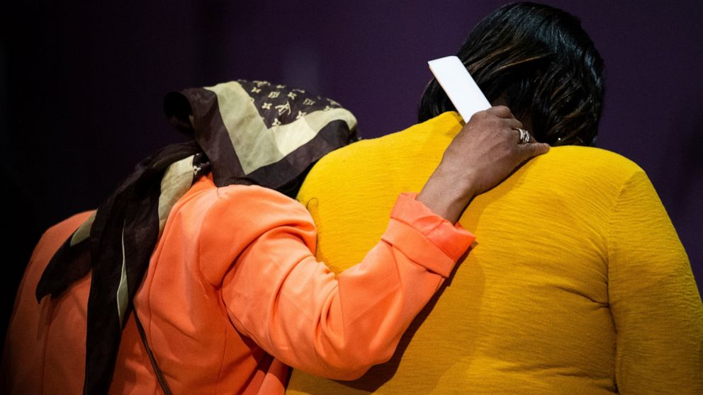Worshippers impacted by the shooting at a Buffalo supermarket pray at True Bethel Baptist Church on Sunday, May 15, 2022, in Buffalo, N.Y. (AP Photo/Joshua Bessex)