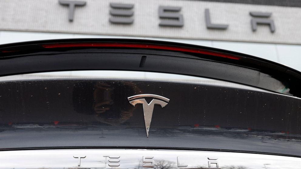 FILE - In this April 26, 2020 photo, the company logo shines off the rear deck of an unsold 2020 Model X at a Tesla dealership in Littleton, Colo. Tesla’s sales from April through June 2022 fell to their lowest quarterly level since last fall as supp