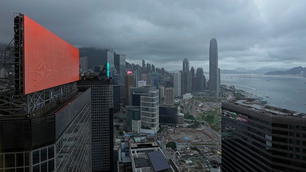 A red advertisement board is seen with backdrop of Hong Kong's business district in Hong Kong Monday, July 19, 2021. U.S. businesses operating in Hong Kong should reassess their operations and decide if the risks of operating in the city are worth th