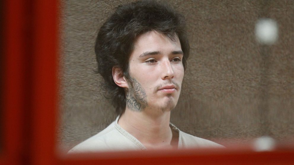 FILE- In this June 3, 2013 file photo, Caleb "Kai" McGillivary waits to be arraigned on murder charges in a Union County jail courtroom in Elizabeth, N.J. McGillivary, who gained Internet fame as "Kai the Hatchet-Wielding Hitchhiker," was sentenced t
