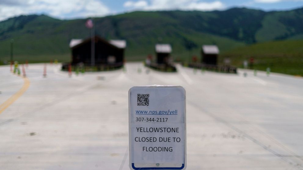 FILE - The entrance to Yellowstone National Park, a major tourist attraction, sits closed due to the historic floodwaters on June 15, 2022, in Gardiner, Mont. Created in 1872 as the United States was recovering from the Civil War, Yellowstone was the