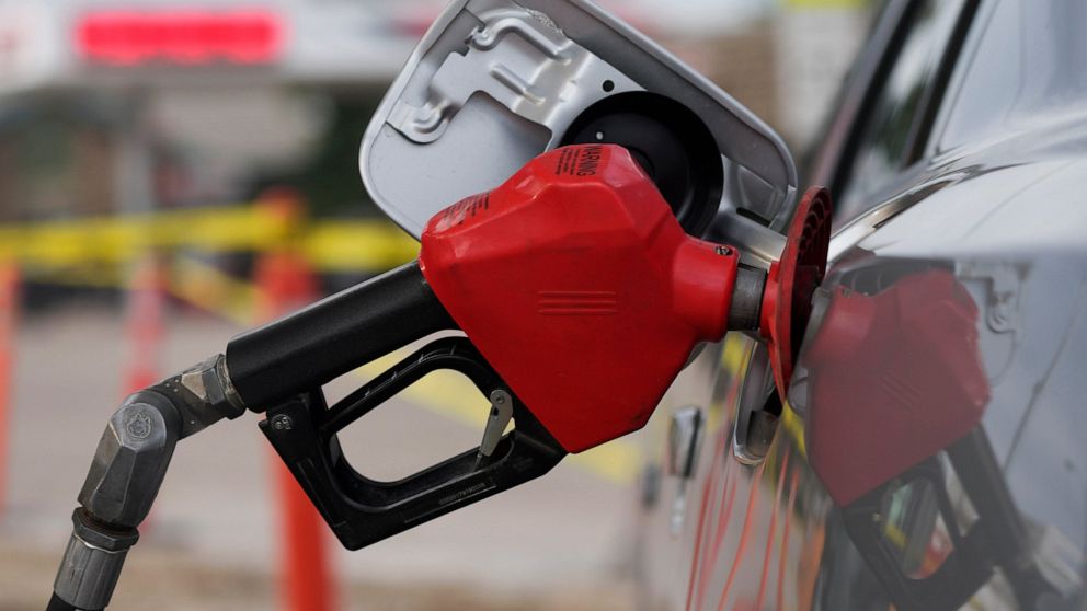 FILE - A motorist fills up the tank on a sedan, July 22, 2022, in Saratoga, Wyo. The average U.S. price of regular-grade gasoline plunged 32 cents over the past two weeks to $4.54 per gallon. Industry analyst Trilby Lundberg of the Lundberg Survey sa