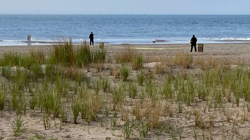 FILE - New York Police investigators examine a stretch of beach at Coney Island where three children were found dead in the surf, Monday, Sept. 12, 2022, in New York. Authorities have confirmed that the children died by drowning. (AP Photo/Joseph Fre