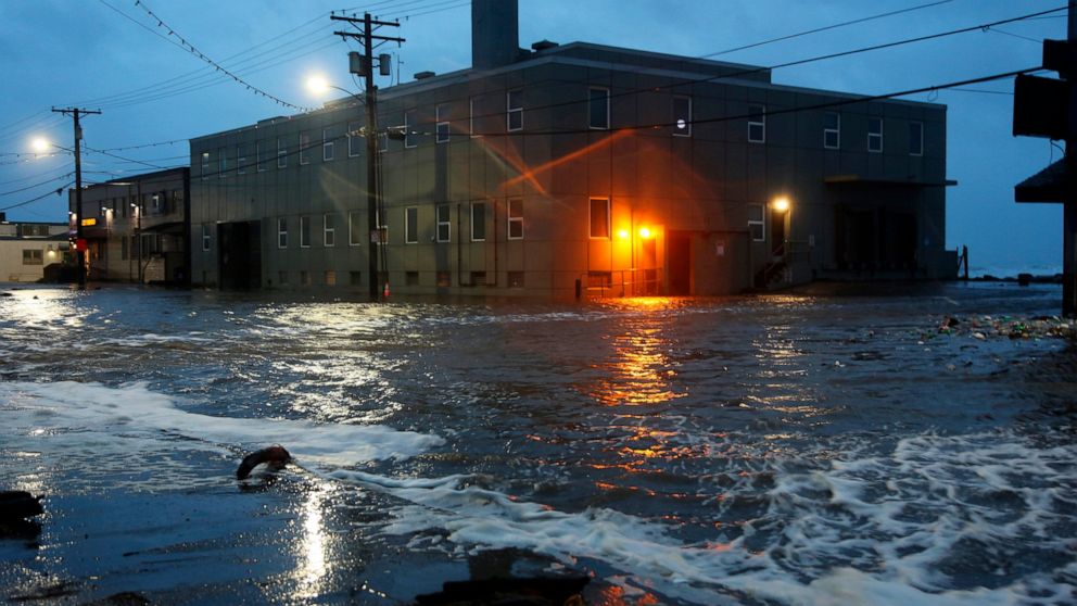 Water rushes down Front Street, just a half block from the Bering Sea, in Nome, Alaska, on Saturday, Sept. 17, 2022 as the remnants of Typhoon Merbok moved into the region. It was a massive storm system — big enough to cover the mainland U.S. from th