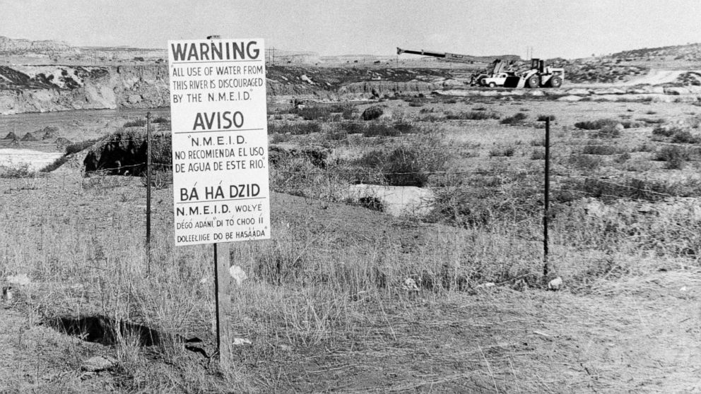 FILE - This Nov. 13, 1975, file photo, shows signs along the Rio Puerco warning residents in three languages to avoid the water in Church Rock, N.M. after a uranium tailings spill. A group representing Navajo communities is presenting its case to an 