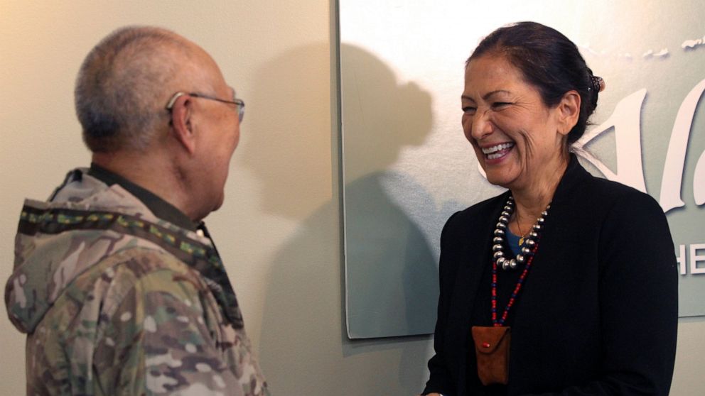 U.S. Interior Secretary Deb Haaland, right, laughs with Nelson Angapak Sr., Thursday, April 21, 2022, in Anchorage, Alaska. Angapak appeared at a news conference with Haaland, who was on a visit to Alaska. (AP Photo/Mark Thiessen)