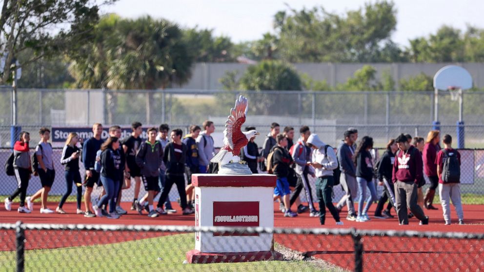 FILE - In this March 14, 2018 file photo, Students from Marjory Stoneman Douglas High School walkout to the football field for 17 minutes of silence in honor of the 17 victims killed at the school. The Florida Supreme Court is blocking an assault wea