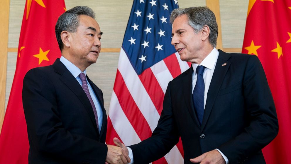 U.S. Secretary of State Antony Blinken, right, shakes hands with China's Foreign Minister Wang Yi during a meeting in Nusa Dua on the Indonesian resort island of Bali Saturday, July 9, 2022. (Stefani Reynolds/Pool Photo via AP)