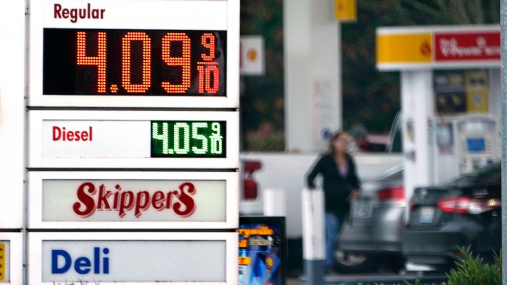 FILE - A driver fills a tank at a gas station Friday, Dec. 10, 2021, in Marysville, Wash. Consumer prices rose 6.8% for the 12 months ending in November, a 39-year high. Many economists expect inflation to remain near this level a few more months but