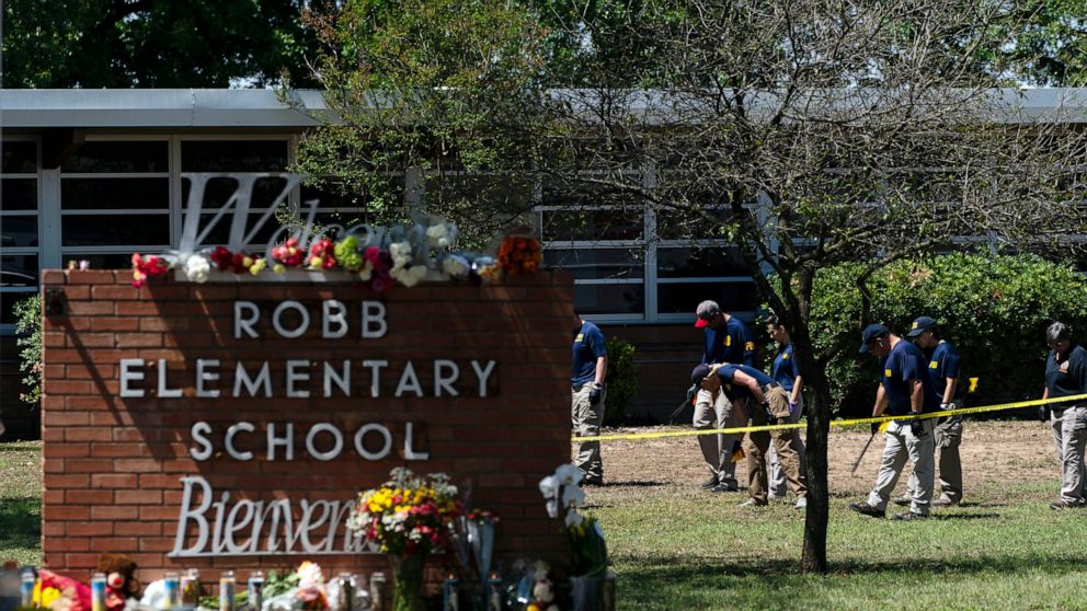 FILE - Investigators search for evidences outside Robb Elementary School in Uvalde, Texas, May 25, 2022, after an 18-year-old gunman killed 19 students and two teachers. The district’s superintendent said Wednesday, June 22, that Chief Pete Arredondo