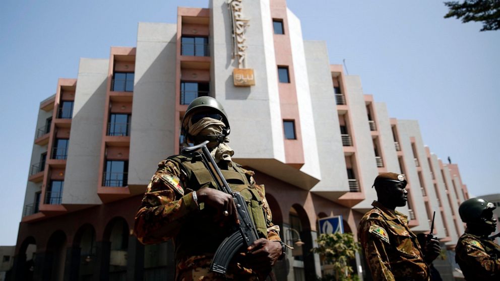 FILE - Soldiers stand guard in front of the Radisson Blu hotel prior to the visit of Malian President Ibrahim Boubacar Keita in Bamako, Mali, Nov. 21, 2015. Fawaz Ould Ahmed Ould Ahemeid, a Mauritanian national, suspected of planning and coordinating