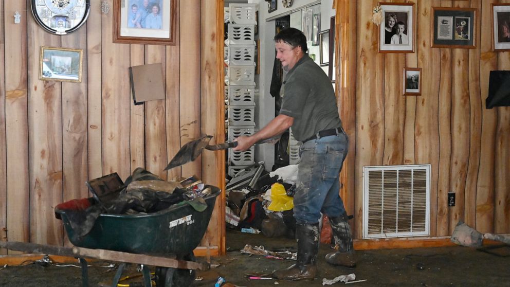 A volunteer from the local Mennonite community in Ogden Hollar help clean mud and debris from flood ravaged homes in Hineman, Ky., Saturday, July 30, 2022. (AP Photo/Timothy D. Easley)