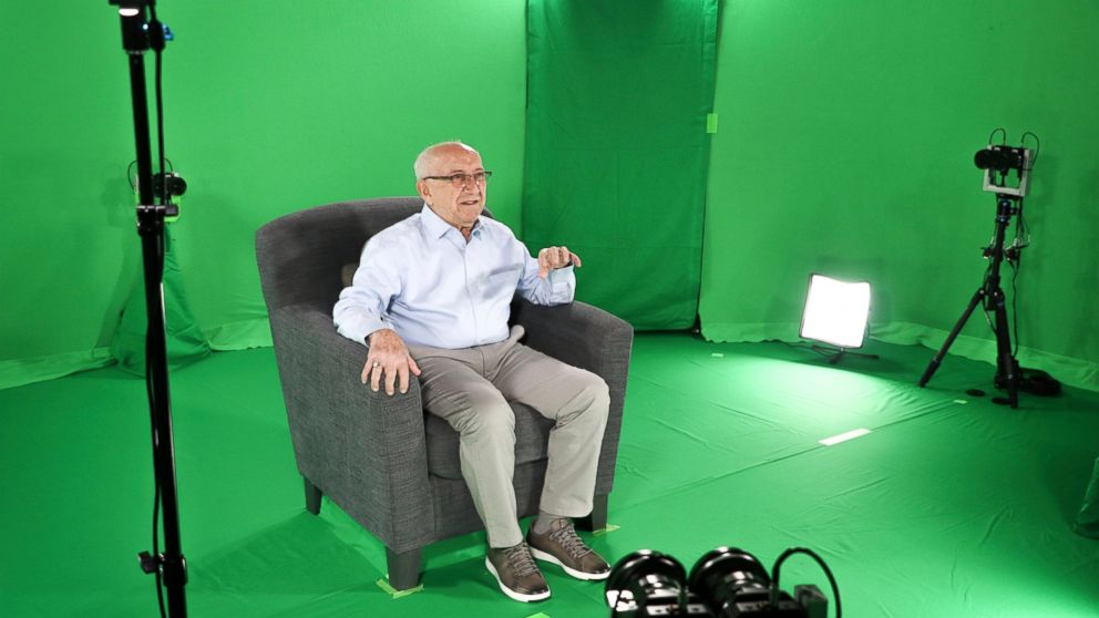 This August 2018 photo shows Holocaust survivor Max Glauben sitting in an interactive green screen room while filming a piece for the Dallas Holocaust Museum in Dallas. Glauben will be the latest to have his story recorded in such a way that generati