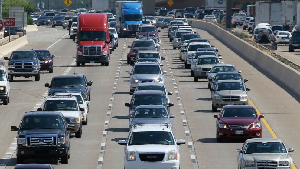FILE - In this July 1, 2016 file photo, drivers work their way out of Dallas during rush hour. The U.S. government's road safety agency says traffic deaths fell by a small amount for the second straight year. The National Highway Traffic Safety Admin