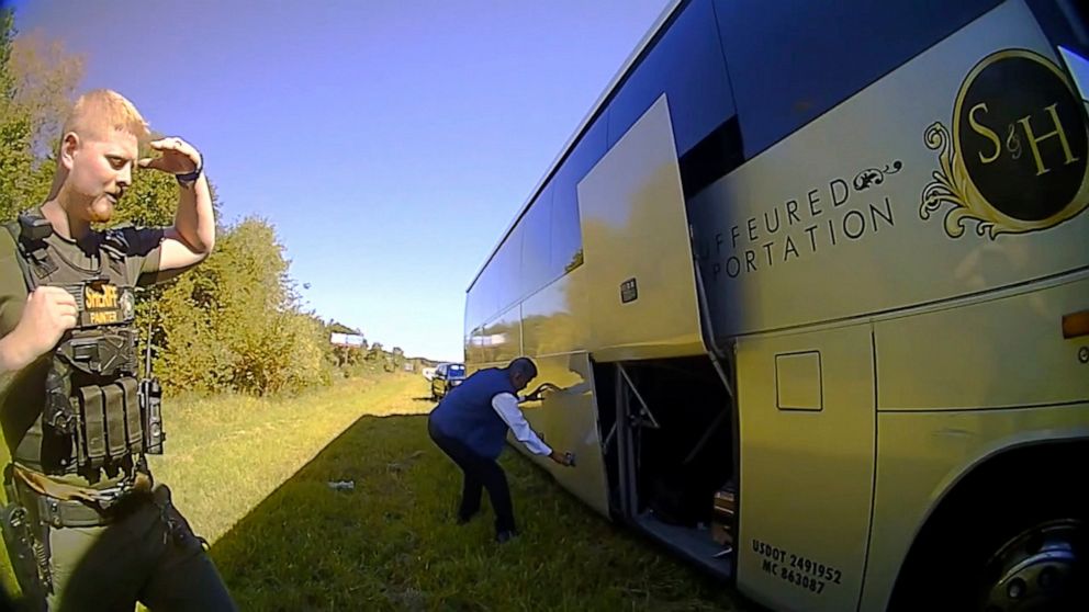 In this screenshot of a video released by Spartanburg County Sheriff's Office, a bus driver opens the storage doors for law enforcement officers on Oct. 5, 2022, after officers in Spartanburg County, S.C., stopped a contract bus transporting students