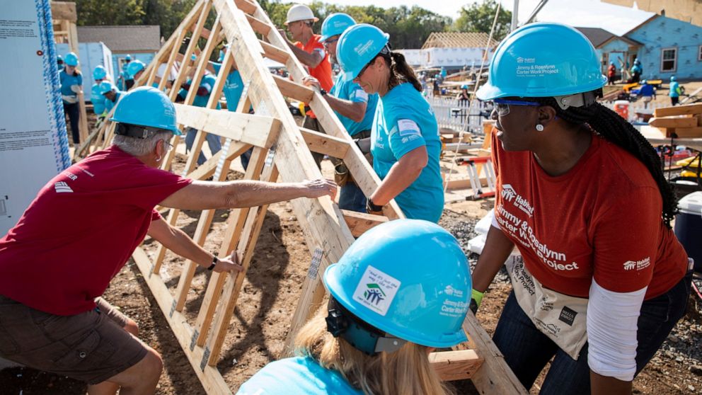 This photo provided by Habitat for Humanity International shows volunteers for Habitat for Humanity International, work on a house at the Carter Work Project in Nashville in 2019. MacKenzie Scott donated $436 million to Habitat for Humanity Internati