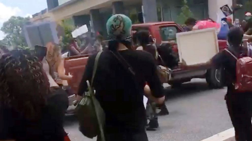 In this image taken from from video provided by @alexisnscott, a pickup truck drives through a crowd of protesters, Saturday, May 30, 2020, in Tallahassee, Fla Tallahassee police said Saturday that the driver was in custody and that no one was seriou
